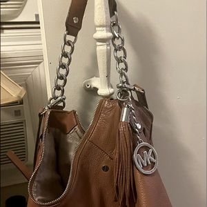 Michael Kors purse can be worn in the shoulder or as a crossbody